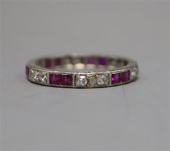 A white metal, ruby and diamond set full eternity ring, size M.